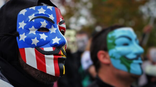 Protesters wearing Guy Fawkes masks.